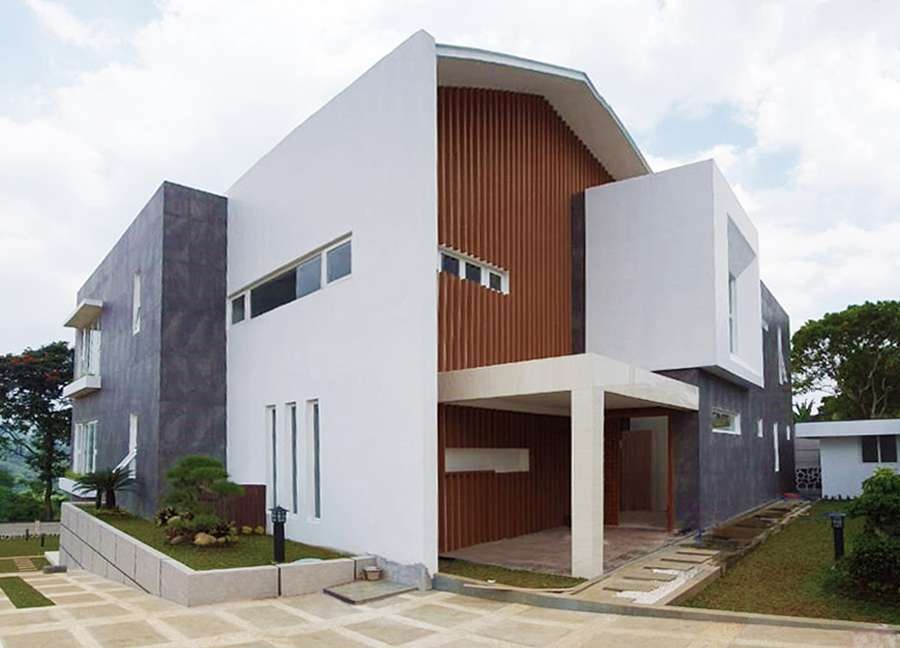 Completed box-form house with a dark timber-slat entrance accent
